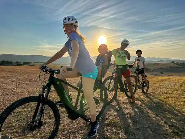 Cyclist on an e-bike at sunset over the Umbrian hills